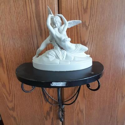Black metal wall shelf with white Cupid and Psyche Statue