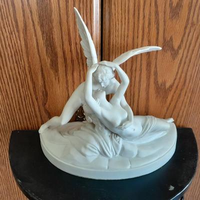 Black metal wall shelf with white Cupid and Psyche Statue