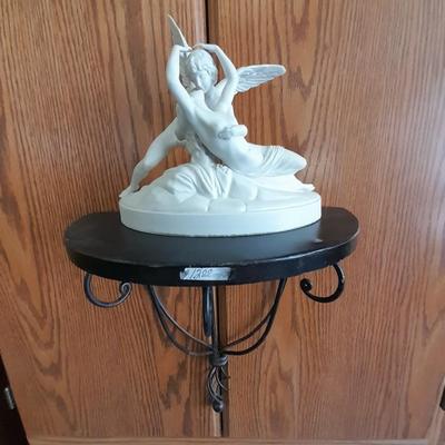 Black metal wall shelf with white Cupid and Psyche Statue