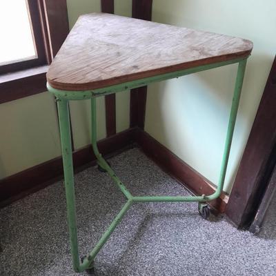 Vintage metal framed triangle shaped table on casters