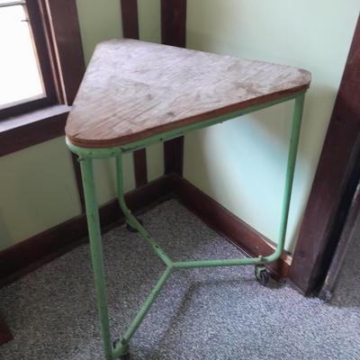 Vintage metal framed triangle shaped table on casters