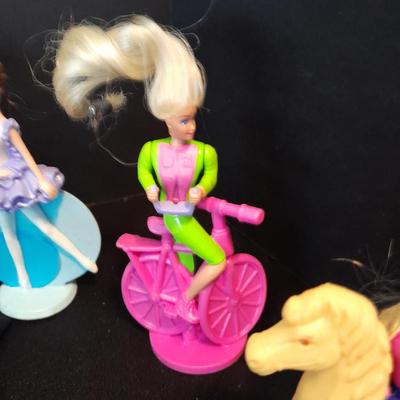 McDonald's Happy Meal toys, Barbie's and Disney characters with a red McDonald's box