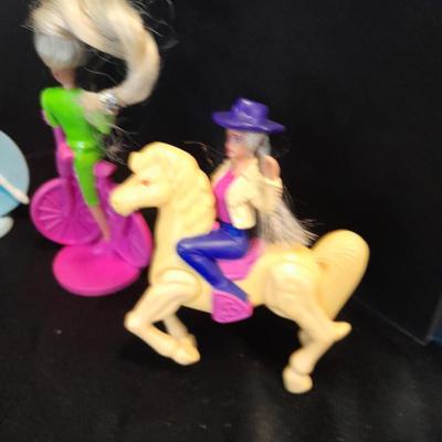 McDonald's Happy Meal toys, Barbie's and Disney characters with a red McDonald's box