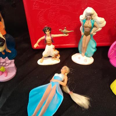 McDonald's Happy Meal toys, Barbie's and Disney characters with a red McDonald's box