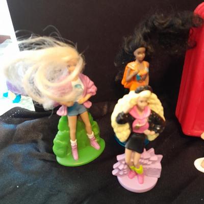 McDonald's Happy Meal toys, Barbie's and Disney characters with a red McDonald's box