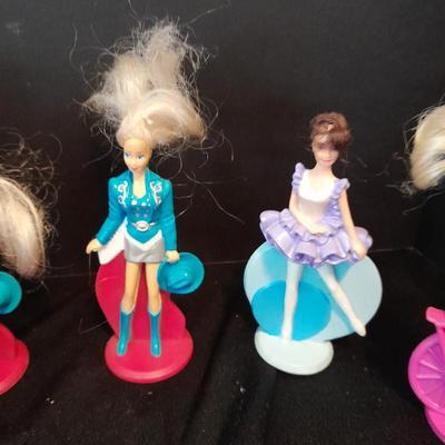 McDonald's Happy Meal toys, Barbie's and Disney characters with a red McDonald's box