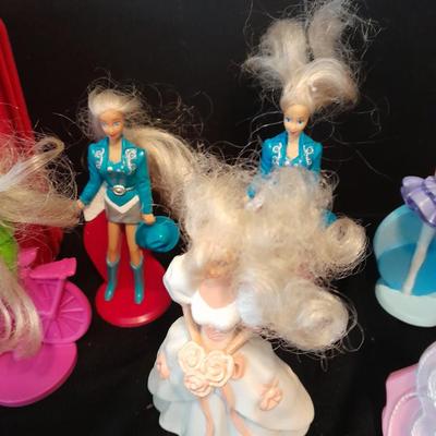 McDonald's Happy Meal toys, Barbie's and Disney characters with a red McDonald's box