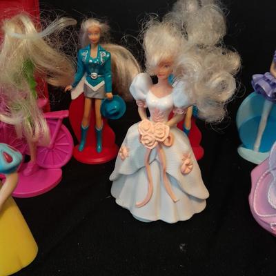 McDonald's Happy Meal toys, Barbie's and Disney characters with a red McDonald's box
