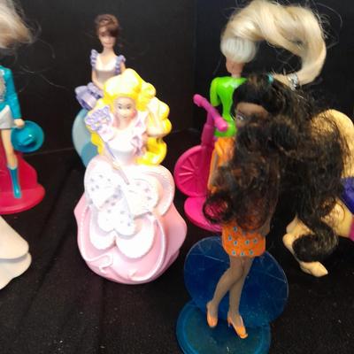McDonald's Happy Meal toys, Barbie's and Disney characters with a red McDonald's box
