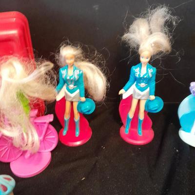 McDonald's Happy Meal toys, Barbie's and Disney characters with a red McDonald's box
