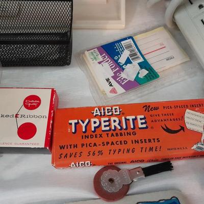 Assortment of office supplies, vintage typewriter items, power strip, office organization and more