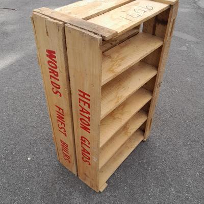 Wooden crate with Metal handled oval Ice tub, tall Fat tire beer bottles and Christmas brew 6 pack bottles.