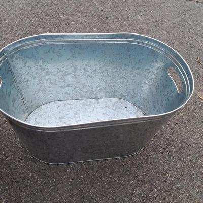 Wooden crate with Metal handled oval Ice tub, tall Fat tire beer bottles and Christmas brew 6 pack bottles.