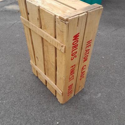Wooden crate with Metal handled oval Ice tub, tall Fat tire beer bottles and Christmas brew 6 pack bottles.