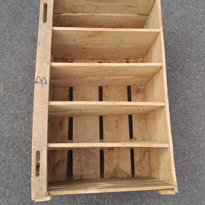 Wooden crate with Metal handled oval Ice tub, tall Fat tire beer bottles and Christmas brew 6 pack bottles.