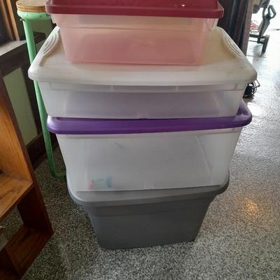 Four Plastic Storage totes of various sizes