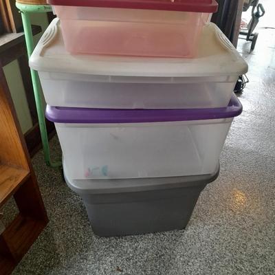Four Plastic Storage totes of various sizes