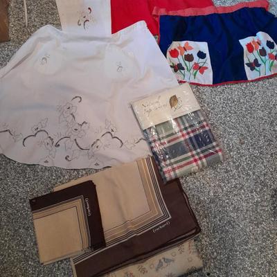Three vintage aprons, Cacharel napkins, and two table cloths