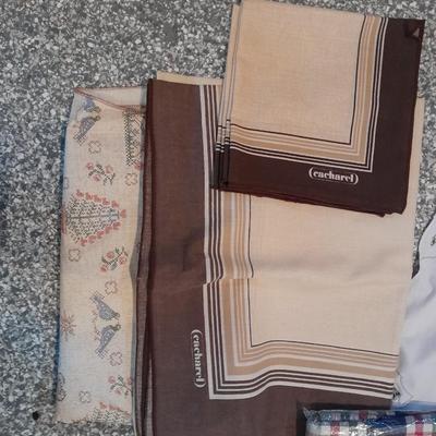 Three vintage aprons, Cacharel napkins, and two table cloths
