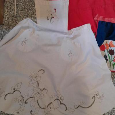 Three vintage aprons, Cacharel napkins, and two table cloths