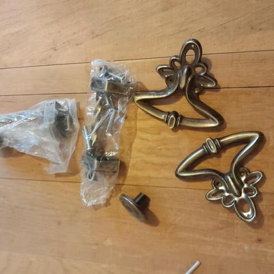 Tupperware organizer with lid, and an assortment of home hardware and lightbulbs