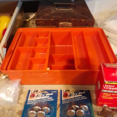 Tupperware organizer with lid, and an assortment of home hardware and lightbulbs