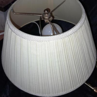 Wall mount Brass Lamp with shade, a free standing can light, and small candle light