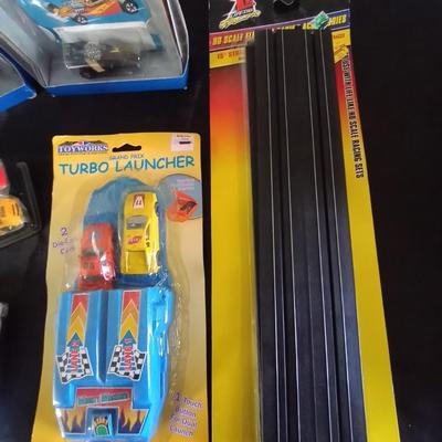 HOT WHEELS AND OTHER RACING CARS- TRACKS AND RACING SHIRT
