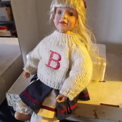 TWO PORCELIAN DOLLS DRESSED IN 50'S ERA