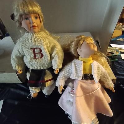 TWO PORCELIAN DOLLS DRESSED IN 50'S ERA