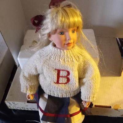 TWO PORCELIAN DOLLS DRESSED IN 50'S ERA