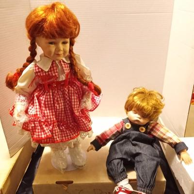 TWO GIRL AND BOY PORCELIAN DOLLS