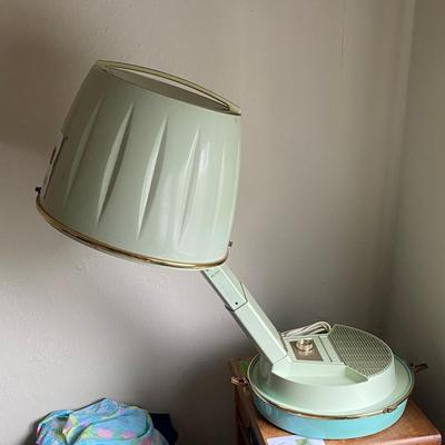 Vintage hairdryer with collection of wigs