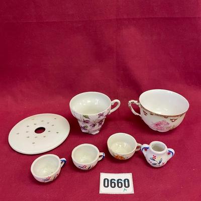 Miniature tea set pieces and tea cups