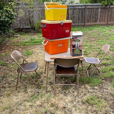 Card table and chairs with vintage coolers and  more