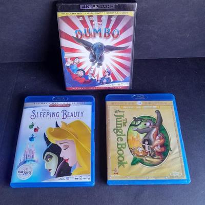 Three Children's movies on DVD Blue Ray Dumbo, Sleeping Beauty, and The Jungle Book