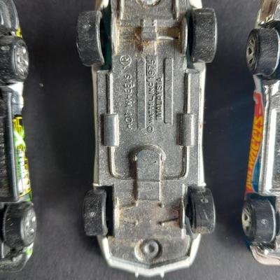 4 Hot Wheel cars and 1 Corgi Brand car