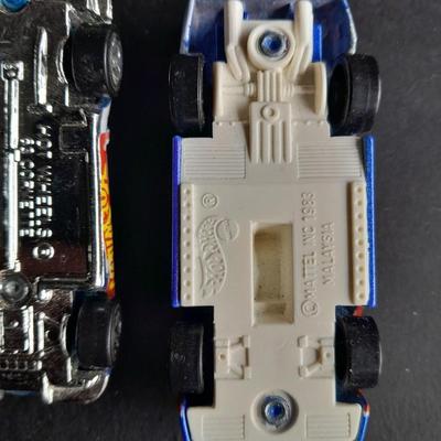 4 Hot Wheel cars and 1 Corgi Brand car