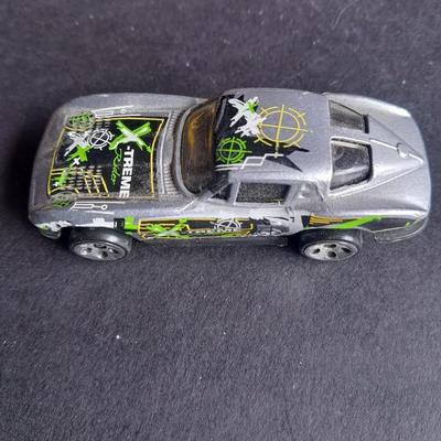4 Hot Wheel cars and 1 Corgi Brand car