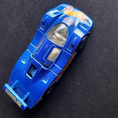 4 Hot Wheel cars and 1 Corgi Brand car