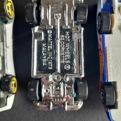 4 Hot Wheel cars and 1 Corgi Brand car