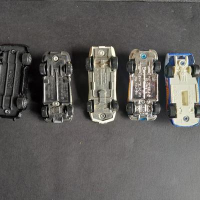 4 Hot Wheel cars and 1 Corgi Brand car