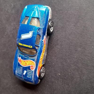 4 Hot Wheel cars and 1 Corgi Brand car