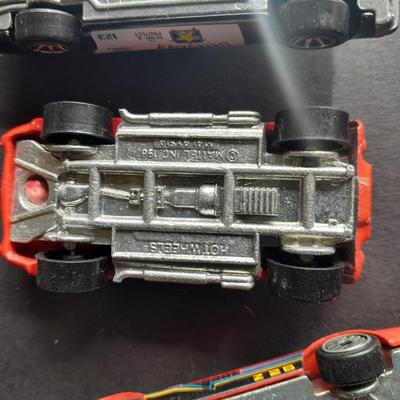 5 Hot Wheel cars and one little metal red car