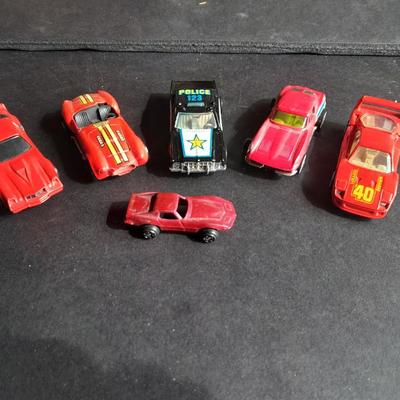 5 Hot Wheel cars and one little metal red car