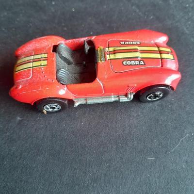5 Hot Wheel cars and one little metal red car