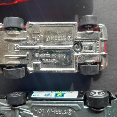 5 Hot Wheel cars and one little metal red car
