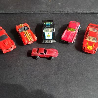 5 Hot Wheel cars and one little metal red car