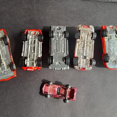 5 Hot Wheel cars and one little metal red car