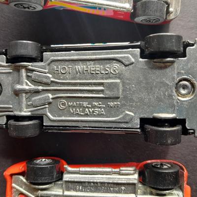 5 Hot Wheel cars and one little metal red car